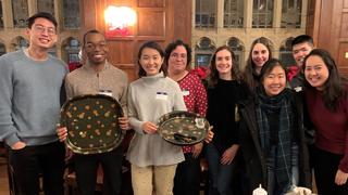 Students in Saybrook College pose with empty plates at the end of their study break.