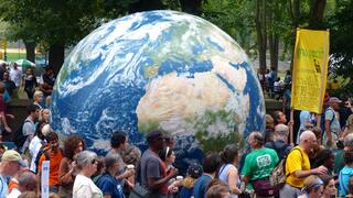 Crowd surrounding giant planet Earth installation