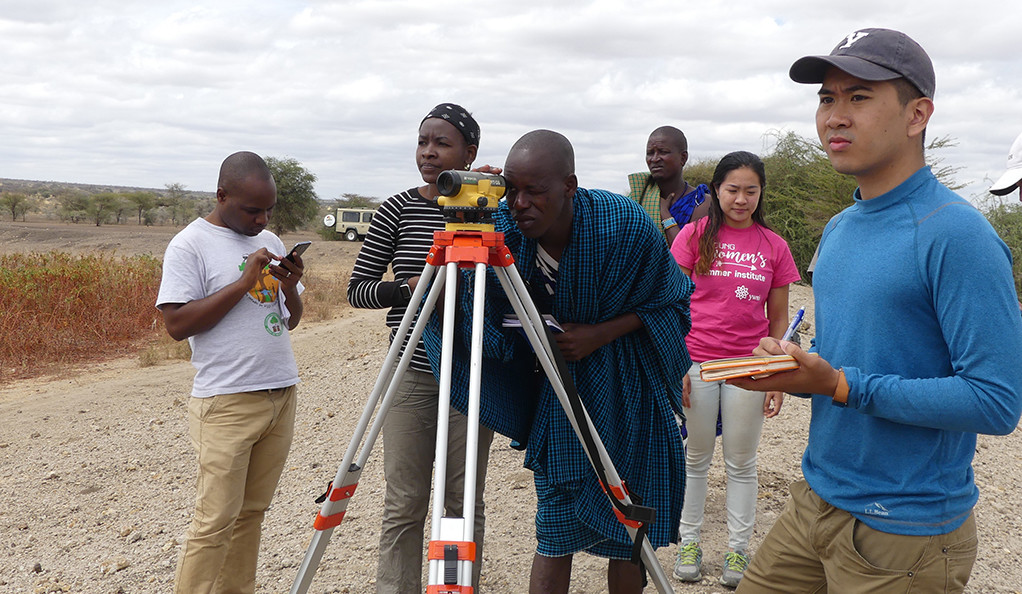 The Engineers Without Borders-Yale team helps local officials in Naitolia, Tanzania survey the top of existing embankment dam. Left to right: Erasto, Tula Ngasala, Ndesa, a Naitolia official, Annabelle Pan, and Patrick Hong. 