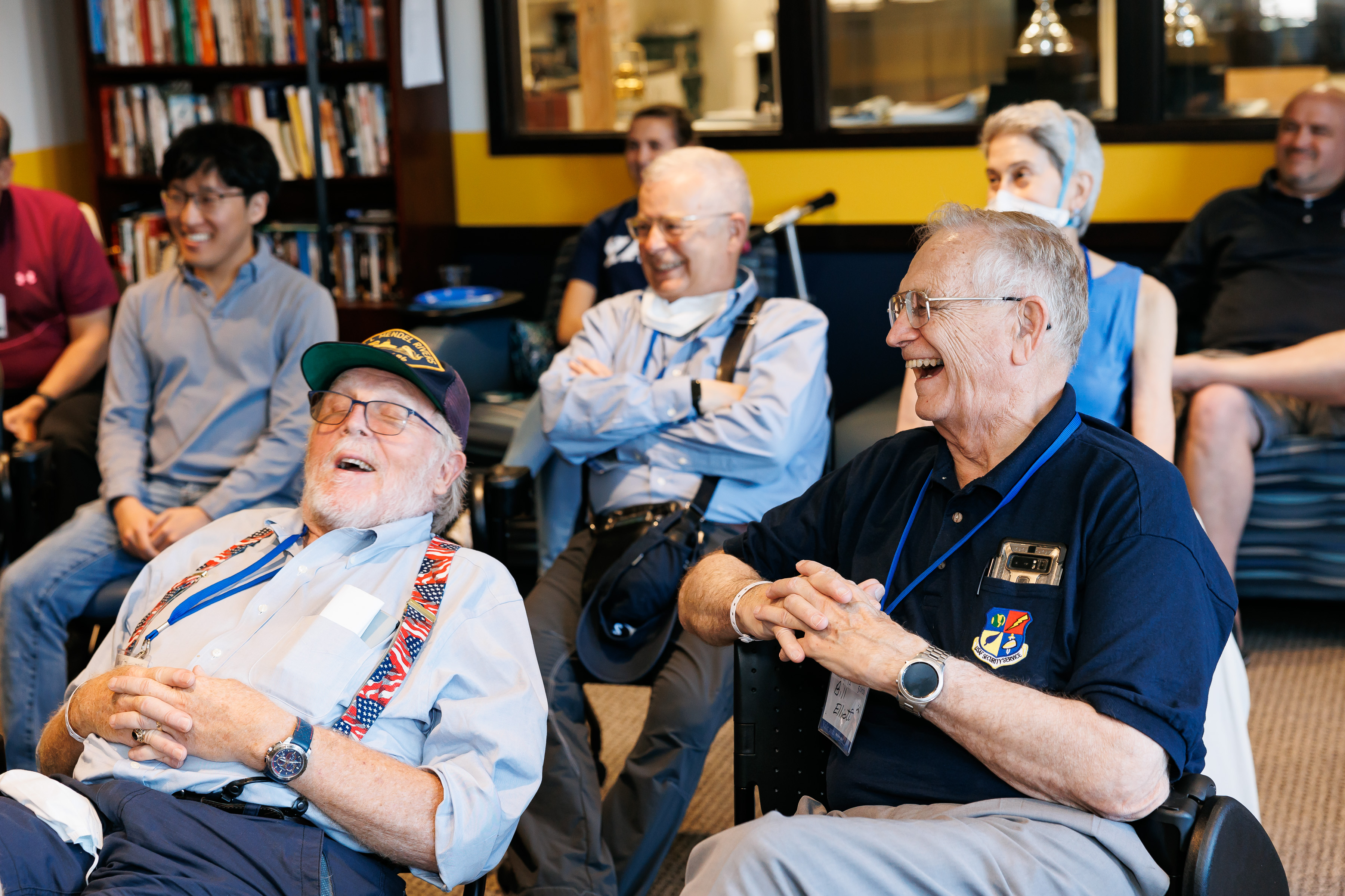 Photo: Rusty Pickett ’72 and Bill Elliott ’72 (front row, left to right) and their fellow veterans share a laugh during one of the event's presentations. Credit: Tony Fiorini