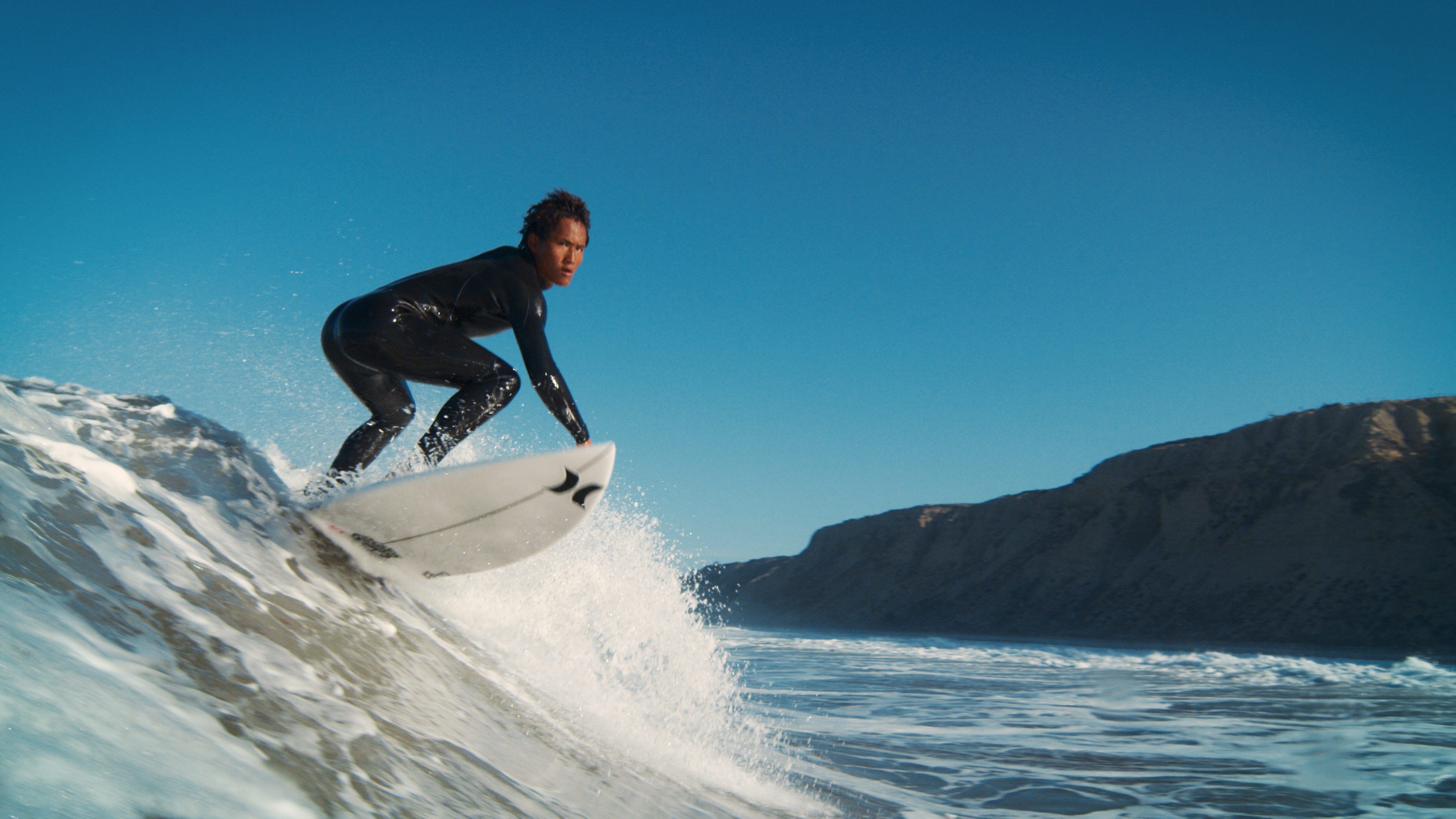 Alex surfing from the movie Surf Nation