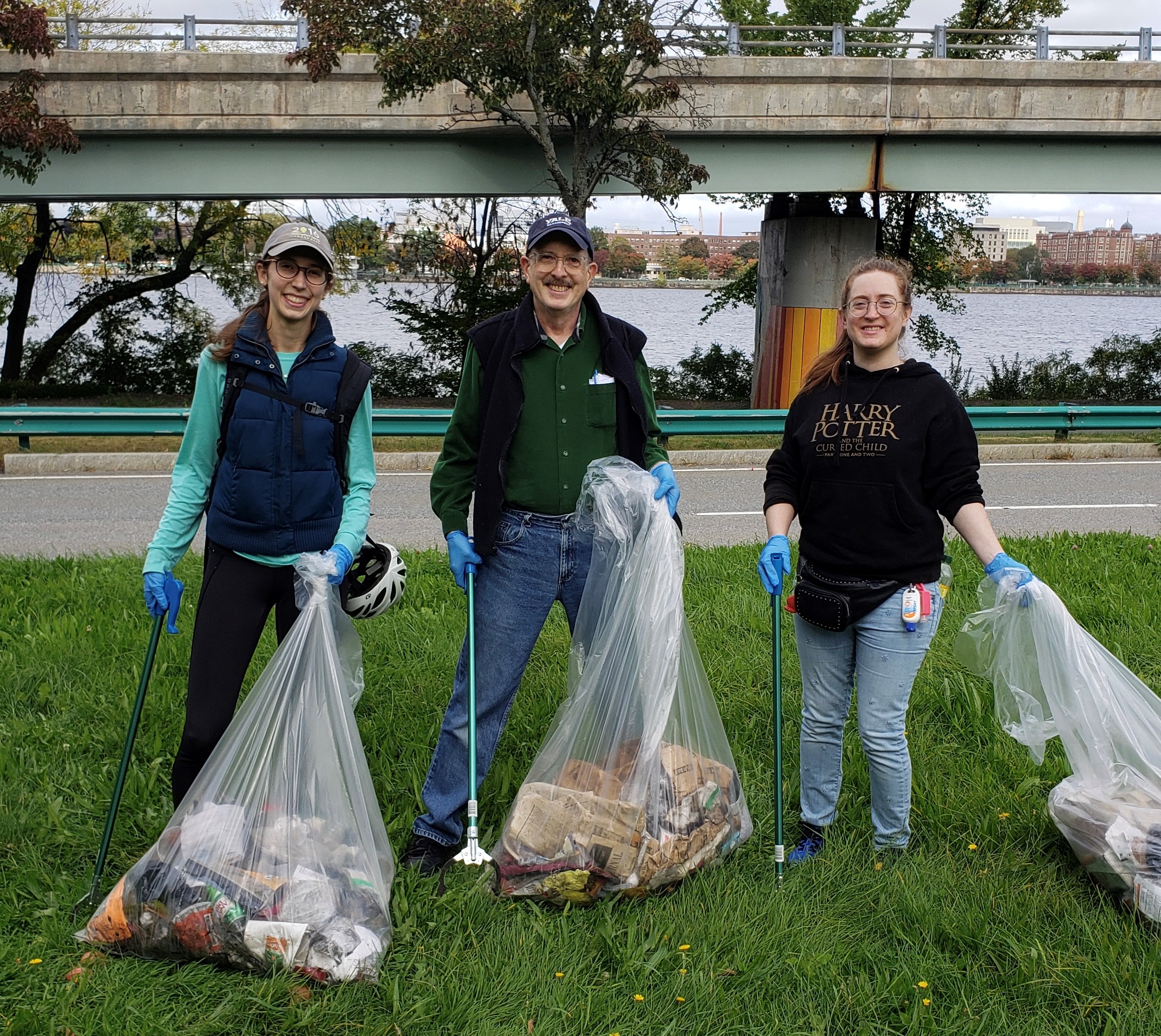 Picture: two women and a man picking up garbage