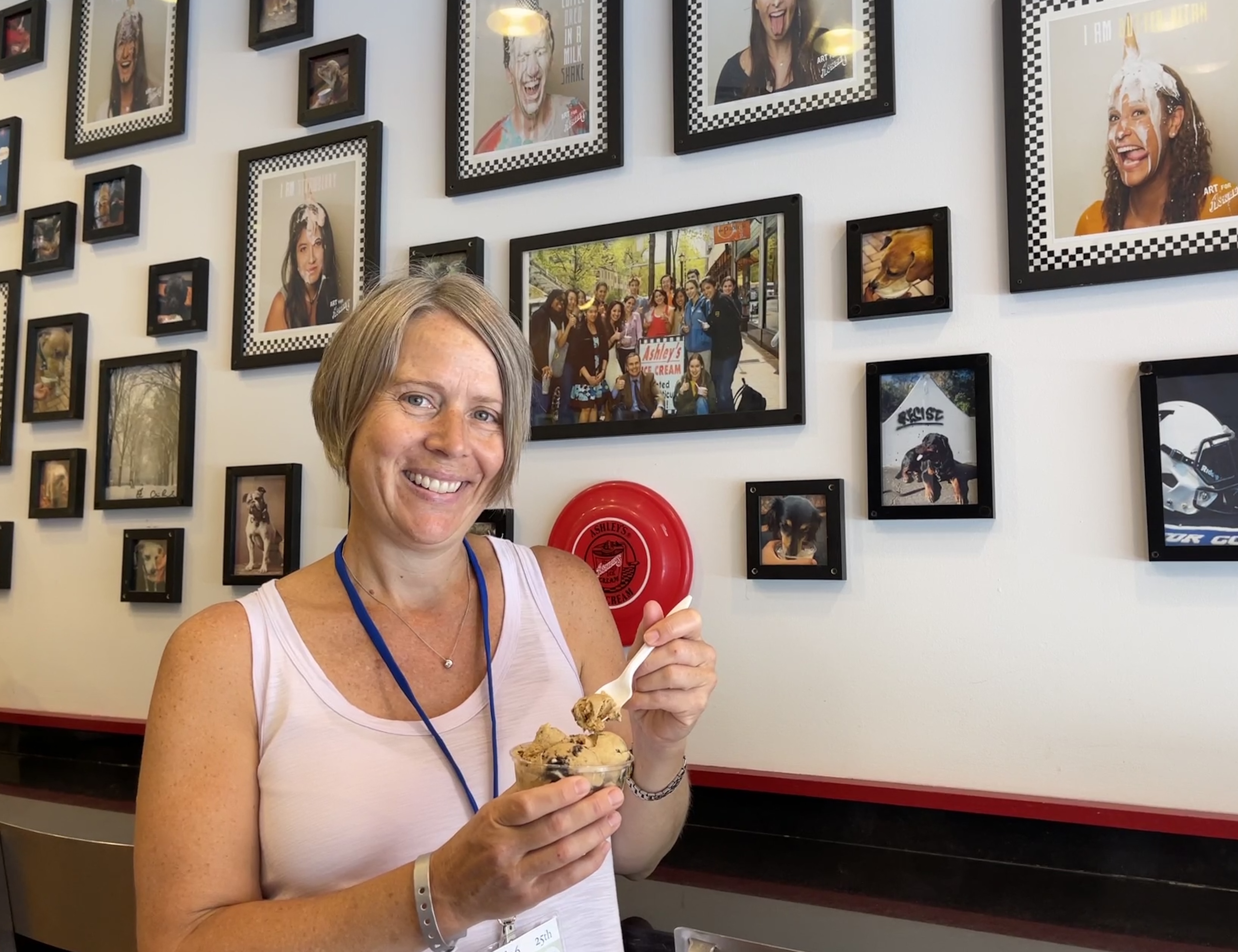 A photo of Nan Rohrer ’96 enjoying a scoop of Coffee Oreo ice cream inside Ashley's Ice Cream.