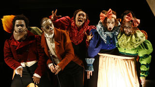actors in masks and costume on stage