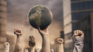 Fist pumps in the air surrounding  and holding the Earth globe