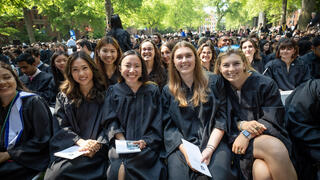 Photo: A host of soon-to-be female graduates pose at the front of the crowd of those celebrating on Old Campus.