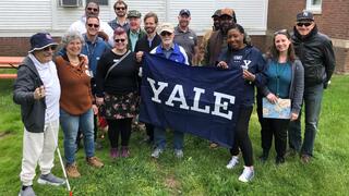 Yale Day of Service volunteers, VA staff, and veterans pose for a group photo at the West Haven VA Medical Center. 