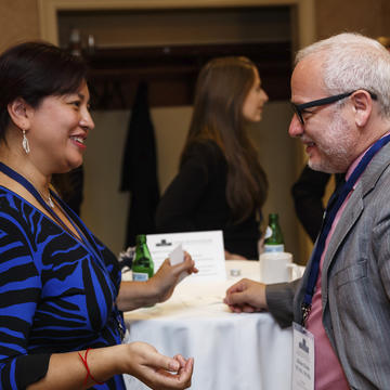 Two alumni talking at a reception